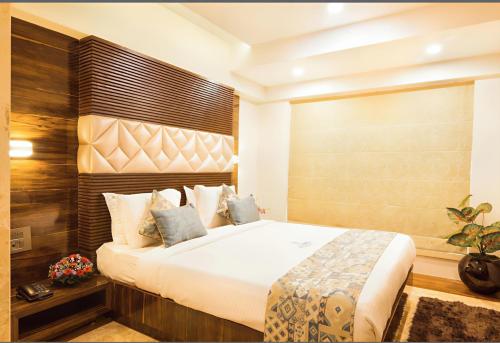 a bedroom with a large bed in a room at Hotel The Green International in New Delhi