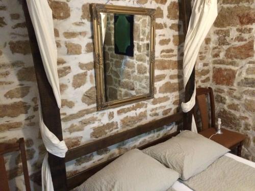 a mirror and a bed in a room at Lieber Hiemell 2 in Betina