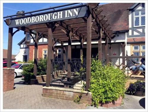 a wooden gazebo with a sign that reads wood brook inn at Woodborough Inn in Winscombe