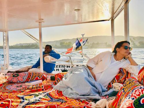 a woman sitting on the back of a boat at Rose Guest House in Luxor