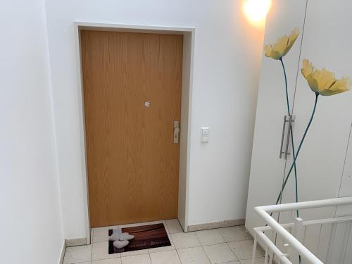 a brown door in a room with a tile floor at Ferienwohnung Ambiente - 3 Zimmer in Bad Säckingen