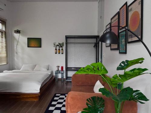 a living room with a bed and a plant at KINARI space Gleam in Hue