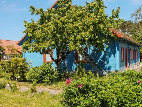 a blue house with a tree in front of it at Rankwitzer Hof in Rankwitz