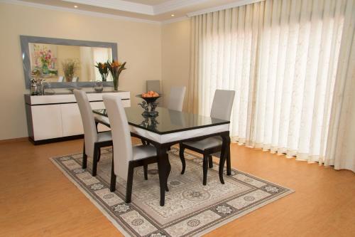 a dining room with a black table and chairs at Elegantes Haus In Santana Mit Garten Und Grill in Faial