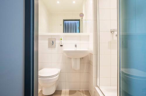 a bathroom with a toilet and a sink at Point A Hotel Edinburgh Haymarket in Edinburgh