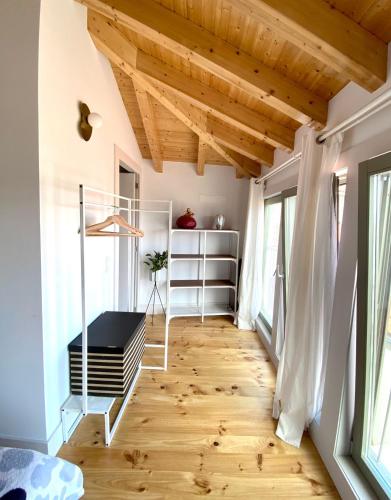 a bedroom with a wooden floor and wooden ceilings at VIVA - Rooftop Terrace View Flat in Porto