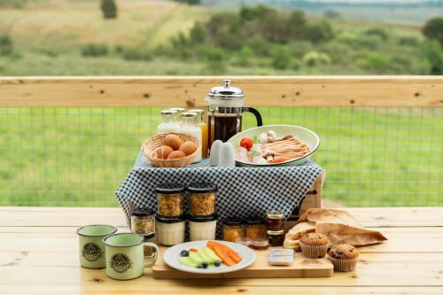 a table with a tray of food on a table at AfriCamps Champagne Valley in Champagne Valley