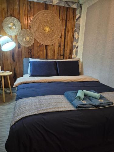 a bedroom with a bed with a blue comforter at Baan Koody Hostel in Ko Kut