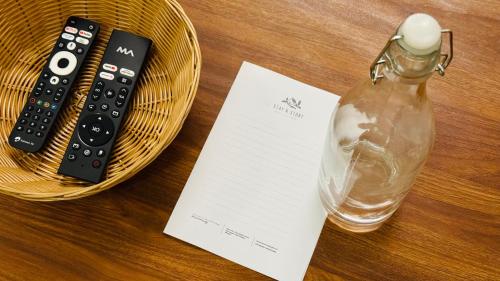a bottle of water and a remote control in a basket at Coco villa in Pālghar