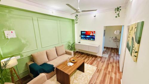 a living room with a couch and a table at Coco villa in Pālghar