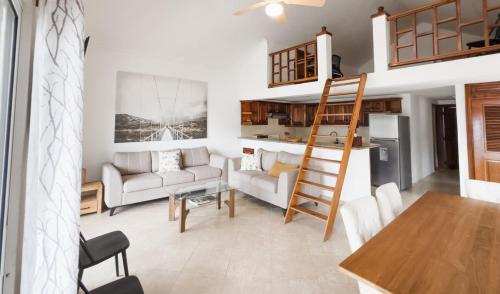 a living room with a ladder and a kitchen at Beautiful second floor apartment with loft 5D in El Francés