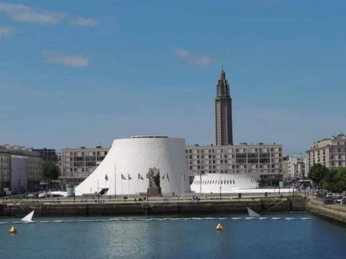 a large building in a city with a body of water at L'observatoire in Le Havre