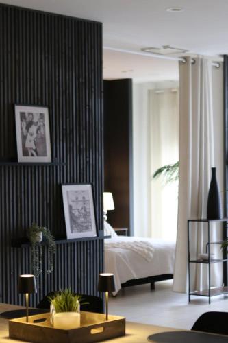 a bedroom with a bed and a table in a room at Casa Verde in Maasmechelen