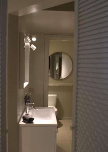 a bathroom with a white sink and a mirror at Casa Verde in Maasmechelen