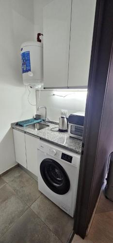 a kitchen with a sink and a washing machine at PARANA Parque y CPC in Paraná