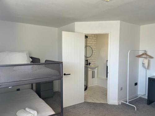 a bedroom with a bunk bed and a bathroom at The Lanes Townhouse Retreat in Brighton & Hove