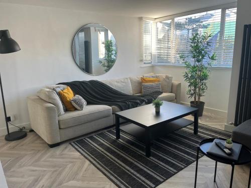 a living room with a couch and a table at The Lanes Townhouse Retreat in Brighton & Hove