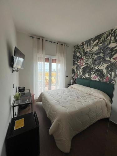 a bedroom with a large bed and a window at Casa Angelina in Mirto