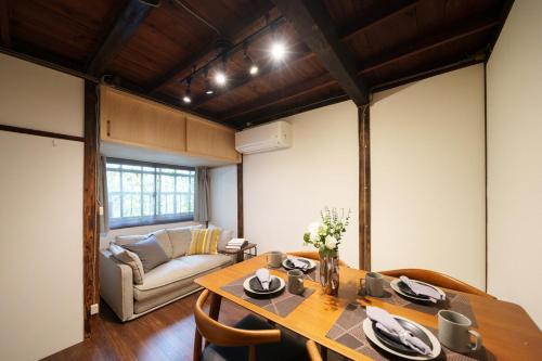 a dining room with a table and a couch at Sen Yokohama 2K house near Bandobashi Sta 横浜阪東橋 in Yokohama