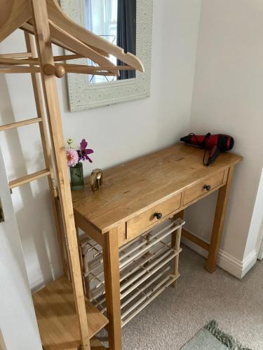 a wooden desk in a room with a ladder at The Eaves, Glastonbury High Street 2 bed 2 bathroom apartment in Glastonbury