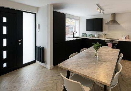a kitchen and dining room with a table and chairs at The Lanes Townhouse Retreat in Brighton & Hove