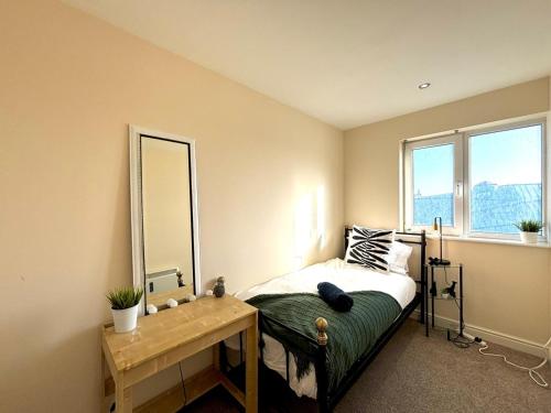 a bedroom with a bed with a mirror and a table at Central Station Apartment in Central Station
