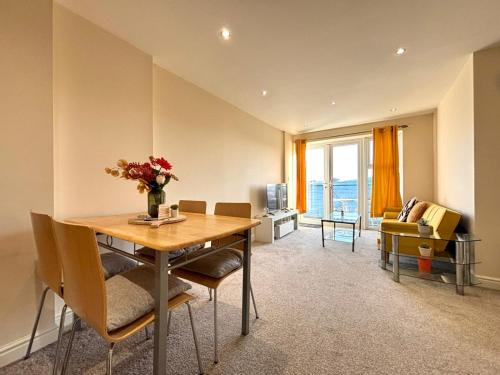 a dining room with a table and chairs and a living room at Central Station Apartment in Central Station