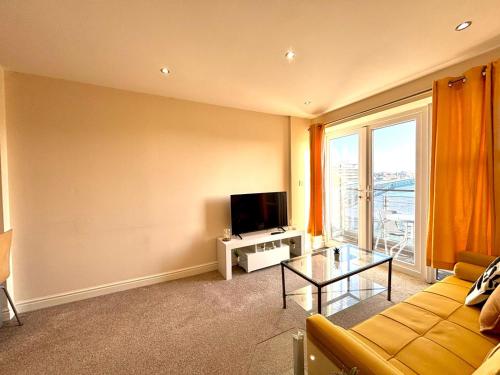 a living room with a couch and a television at Central Station Apartment in Central Station