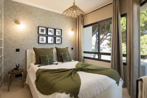 a bedroom with a large bed and a window at Dona Marieta House in Vilamoura