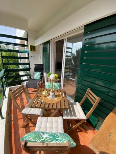 a patio with a table and chairs on a deck at Neptuno IV - Vilamoura in Quarteira