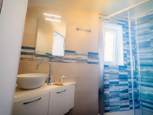 a bathroom with a sink and a shower at Tortolì Old Town in Tortolì