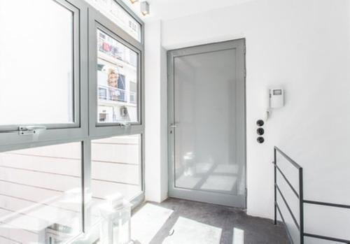 a white room with a door and a window at Pink Mango Hostel in Athens