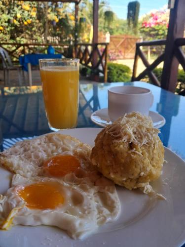 a plate of eggs and biscuits and a glass of orange juice at Sol de Playa in Playas