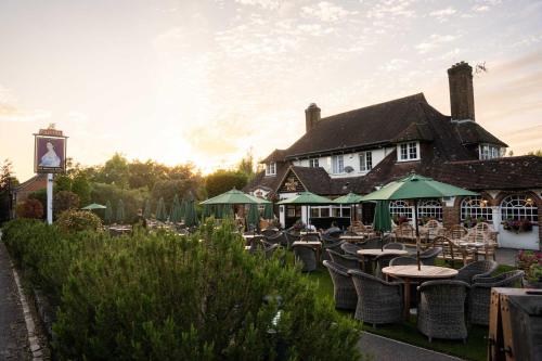 a group of tables and chairs in front of a building at The Princess Royal in Farnham