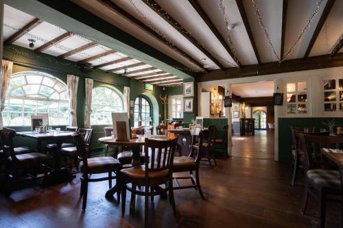 a restaurant with tables and chairs in a room at The Princess Royal in Farnham