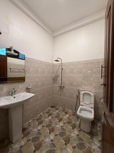 a bathroom with a sink and a toilet at Anna Tourist Inn in Negombo