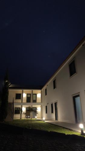 a large white building at night with lights at Quinta do Codeçal in Vila Real
