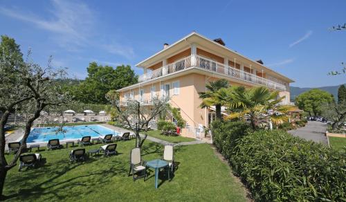 a building with a swimming pool and a resort at Hotel Panoramica in Salò