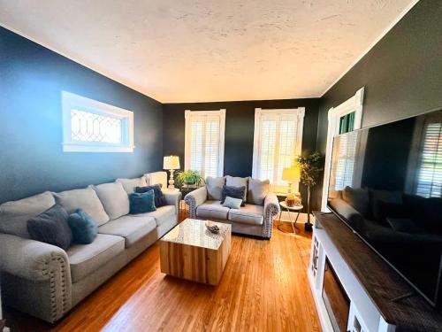 a living room with a couch and a table at The Hamilton Harbor House in Oswego