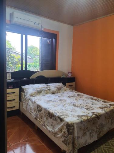 ein Schlafzimmer mit einem Bett und einem Fenster in der Unterkunft Sítio do Berger in São Gabriel