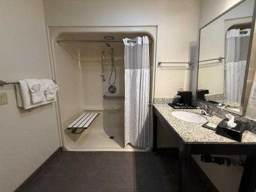 a bathroom with a shower and a sink at SureStay by Best Western Roseburg in Roseburg
