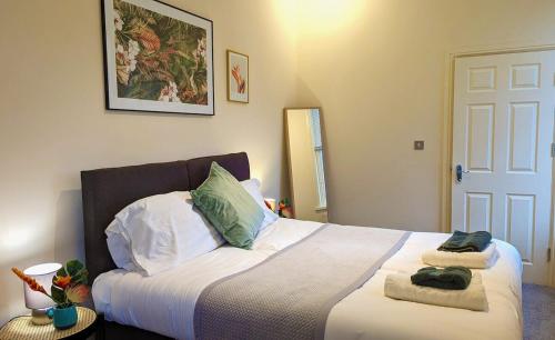 ein Schlafzimmer mit einem Bett mit zwei Handtüchern darauf in der Unterkunft Leamington Spa Warwick Place Apartments in Leamington Spa