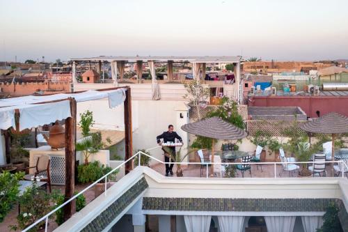 a man standing on the roof of a building at Riad Le Coq Berbère in Marrakech