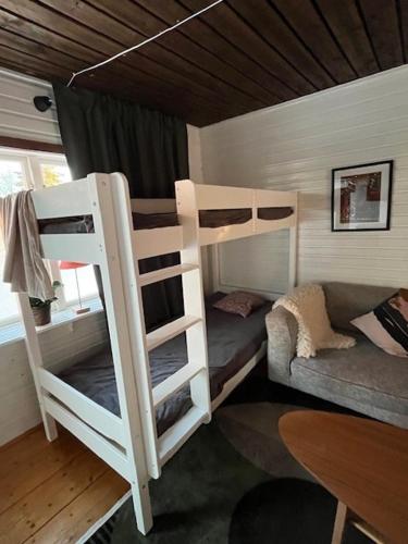 a room with two bunk beds and a table at NorrskensRo in Kiruna