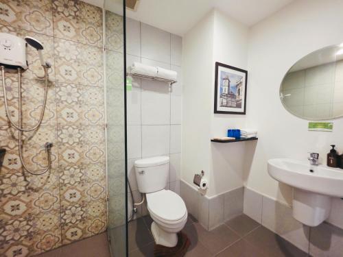 a bathroom with a toilet and a sink and a shower at Recenta Phuket Suanluang by Deevana in Phuket