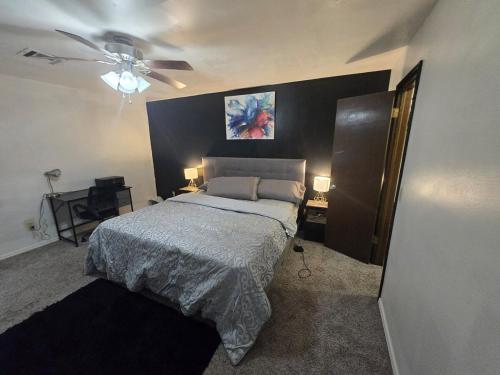 a bedroom with a bed and a ceiling fan at Loue house in edmond, oklahoma by UCO in Edmond