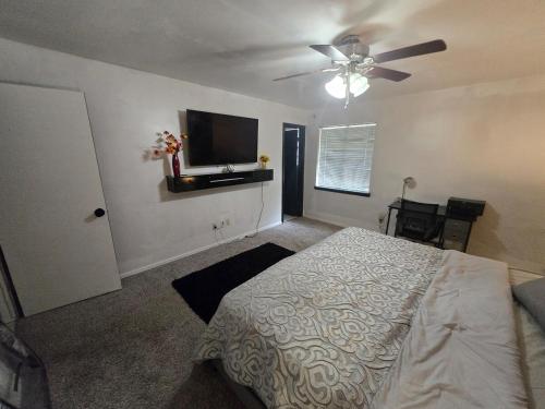 a bedroom with a bed and a ceiling fan at Loue house in edmond, oklahoma by UCO in Edmond