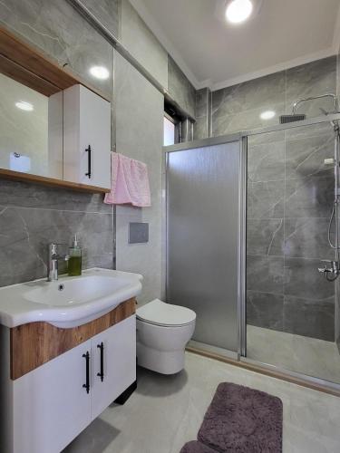 a bathroom with a toilet and a sink and a shower at Villa Hakan 1 - Luxury duplex villa in Dalaman