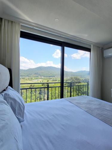 a bedroom with a bed and a large window at Villa Hakan 1 - Luxury duplex villa in Dalaman