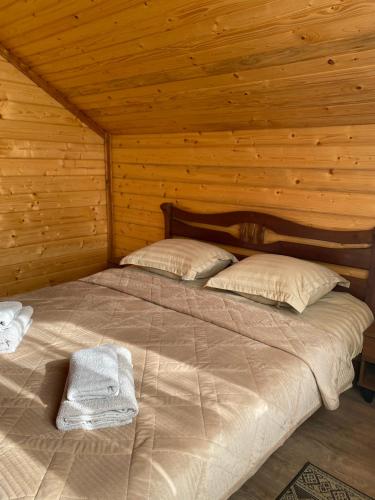a bedroom with a bed in a wooden cabin at Center Cottage Чан in Slavske